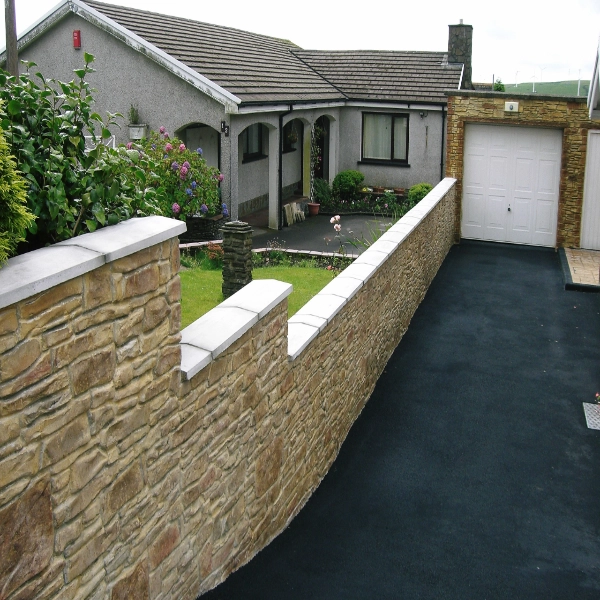 clean softwashed wall to left of tarmac driveway